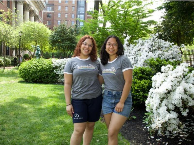 Barnard store student workers posing on Futter Field with spring flowers